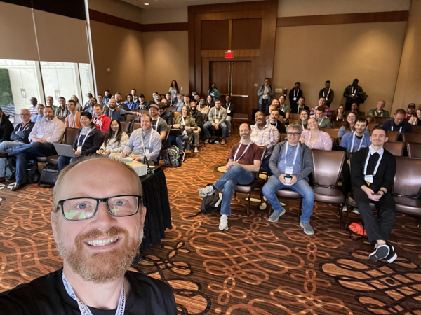 A photo of Brandon Bruno and the audience for his presentation behind him.